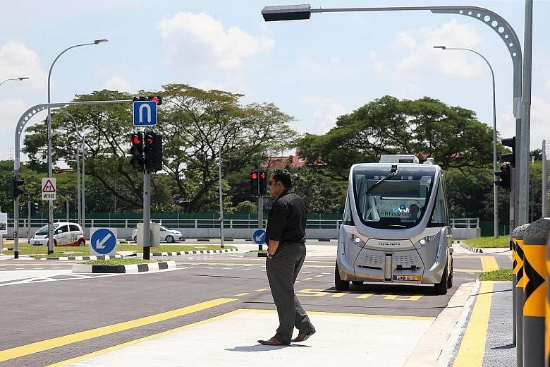A "jay-walker" passing in front of a Navya self-driving shuttle bus at the new autonomous vehicle test centre. It will provide a "safe, controlled and configurable" testing environment for AV developers to test their technologies using a range of sim
