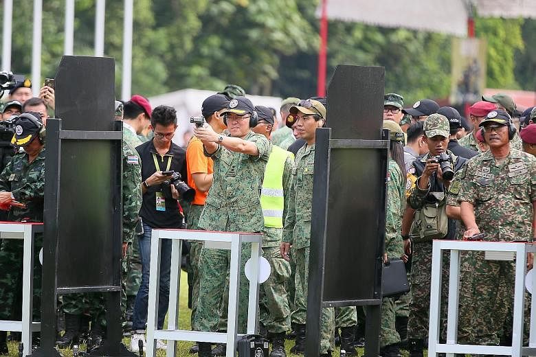 SAF soldiers performing part of their close combat training as one of the performance items for yesterday's Asean Armies Rifle Meet (AARM) closing ceremony. AARM is an annual event that aims to deepen military ties in the region through a rifle compe