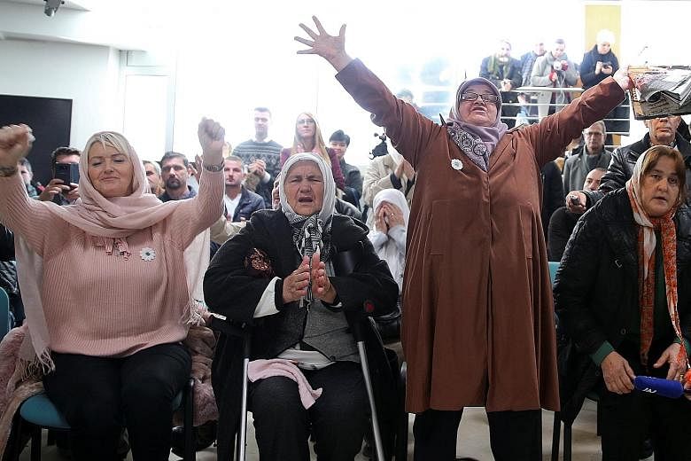 Women in the memorial centre Potocari near Srebrenica, Bosnia and Herzegovina, reacting yesterday as they watched a television broadcast of the court proceedings of former Bosnian-Serb general Ratko Mladic. Ratko Mladic was found guilty on 10 counts,