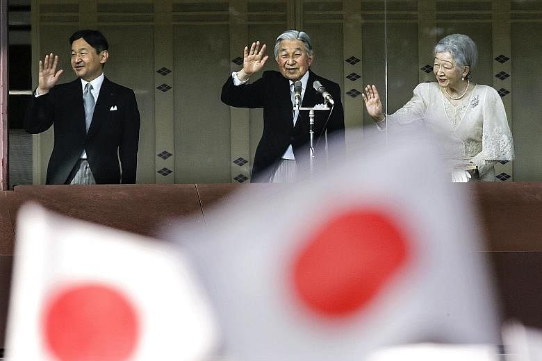 Emperor Akihito (centre), with Empress Michiko and Crown Prince Naruhito, waving to well-wishers celebrating the Emperor's 83rd birthday at the Imperial Palace in Tokyo on Dec 23 last year. He turns 84 next month.