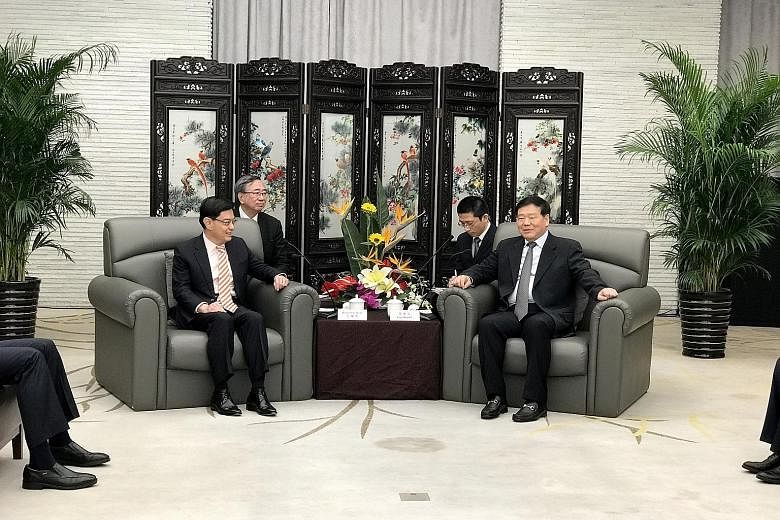 Finance Minister Heng Swee Keat (left) with Jiangsu party secretary Lou Qinjian in Suzhou yesterday. They discussed areas of cooperation and ways for both sides to help companies go international.