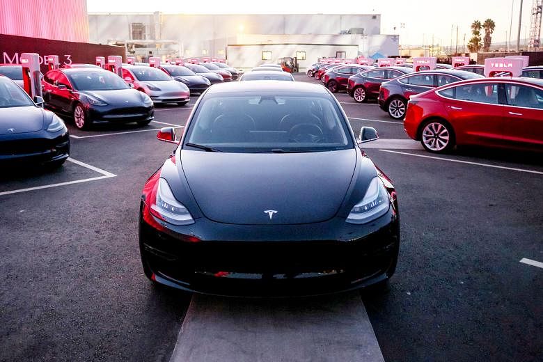 Tesla Model 3 cars at a factory in California. Tesla has said it is ramping up output of the model, which will bring money in the door. It has a target of producing 5,000 of the sedans by the end of March next year.