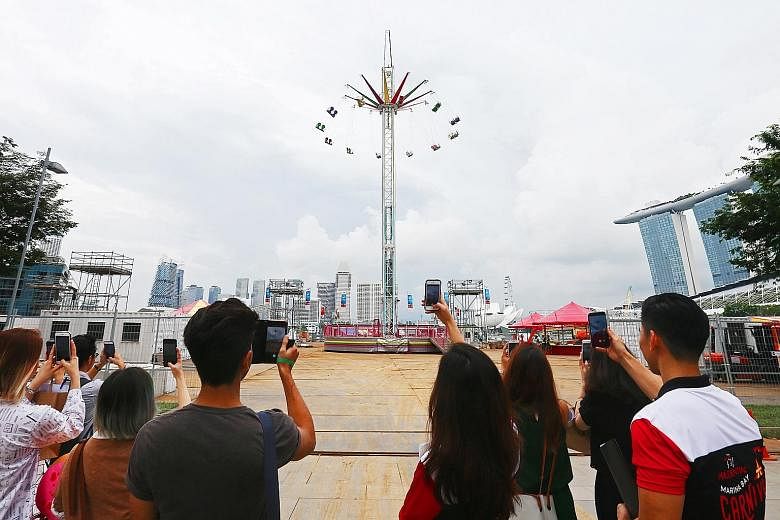 Far left: The Star Flyer, a ride that enables visitors to take in a 360-degree view of the Singapore skyline while experiencing the sensation of flying. It is the first time the ride is in Singapore. Left: One of the game stalls which will be availab
