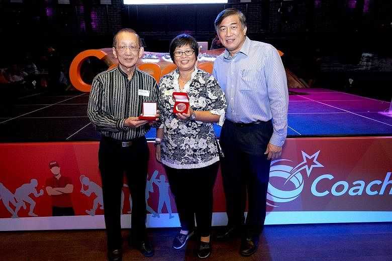 Former table tennis coach Chia Chong Boon and archery coach Rachel Sng were among 105 coaches recognised at the inaugural Coaches Appreciation Night. With them is SportSG CEO Lim Teck Yin.