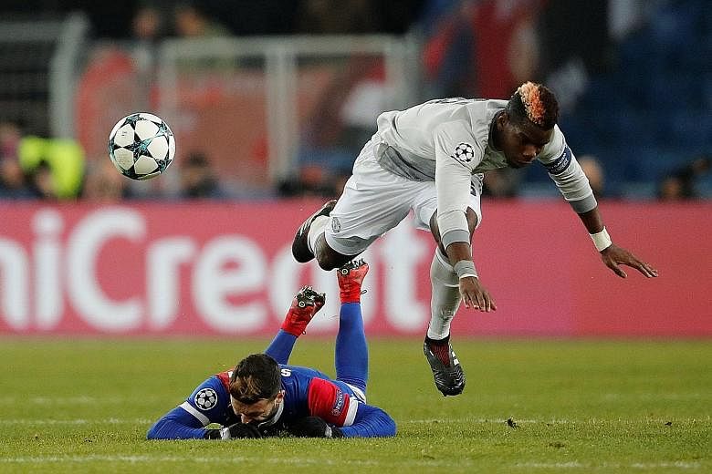 Left: Basel's Renato Steffen competing with Manchester United midfielder Paul Pogba on Wednesday. The Swiss club saw more of the ball once the Frenchman went off in the 65th minute. Below: Basel's Michael Lang celebrating his 89th-minute goal. Despit