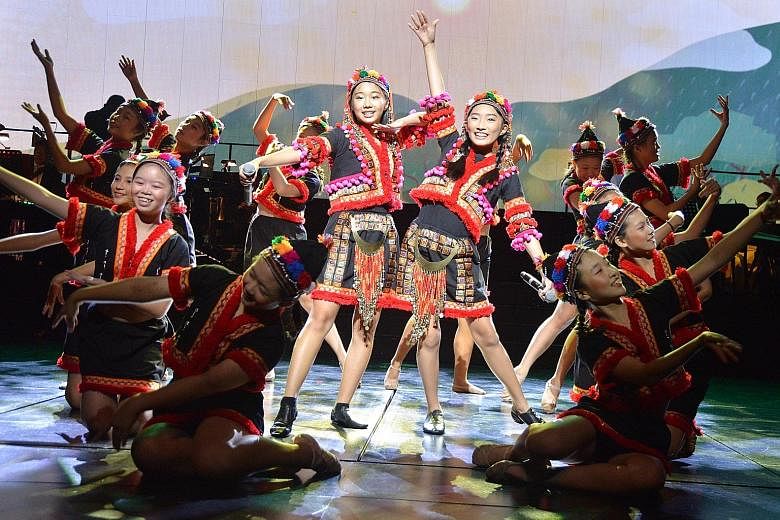 Singers Natanya Tan (left) and Verlene Chew, both 12, are flanked by the Dance Inspiration team as they perform the Taiwan segment of ChildAid at one of the final full-dress rehearsals yesterday for the charity concert. Titled An Amazing, Awesome Asi