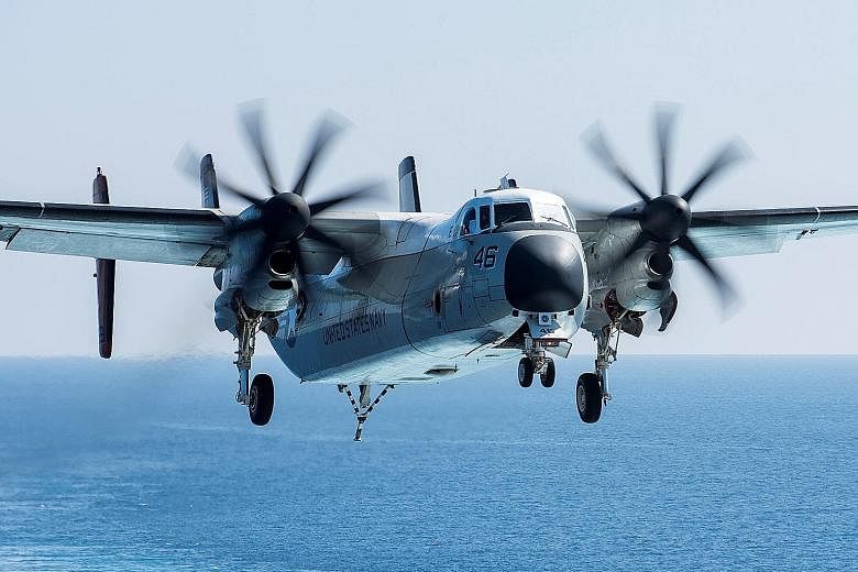 File photo of a C-2A Greyhound logistics aircraft, a re-supply workhorse for US aircraft carriers, routinely ferrying cargo, mail and people onto and off the globally deployed vessels.