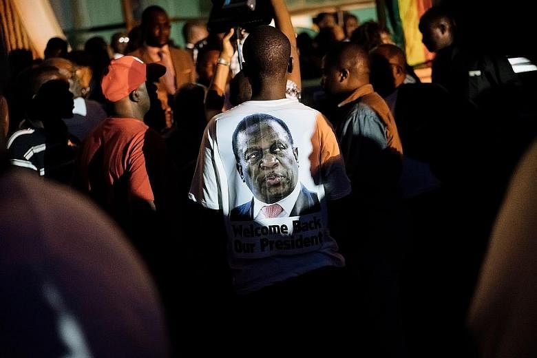 A Mnangagwa supporter wearing a T-shirt emblazoned with the incoming president's image at the headquarters of Zimbabwe's ruling Zanu-PF party in Harare on Wednesday. Mr Emmerson Mnangagwa will be sworn in as president today.