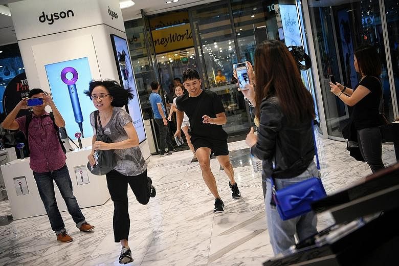 6.45am: People in line outside Robinsons The Heeren in Orchard Road yesterday. Some had been queuing since Thursday. 7am: Shoppers sprinting into Robinsons The Heeren right after the doors opened.
