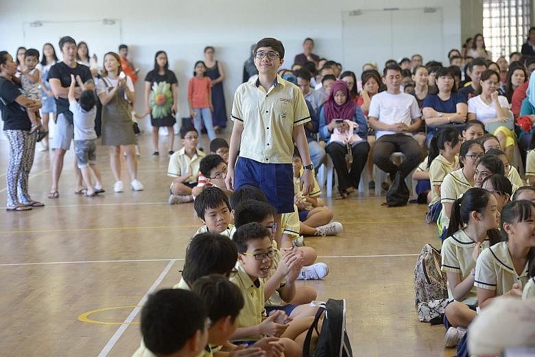 Pupils gathering at Lakeside Primary School to collect their PSLE results yesterday. Schools islandwide celebrated not only top performers, but also those who overcame the odds or did well in non-academic areas.
