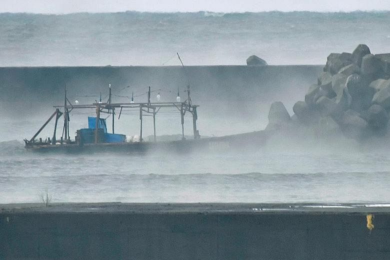 The wooden boat that had carried the eight men was spotted in front of a breakwater in Yurihonjo, in Japan's Akita prefecture, yesterday. A police official said the men appeared to be fishermen rather than defectors.