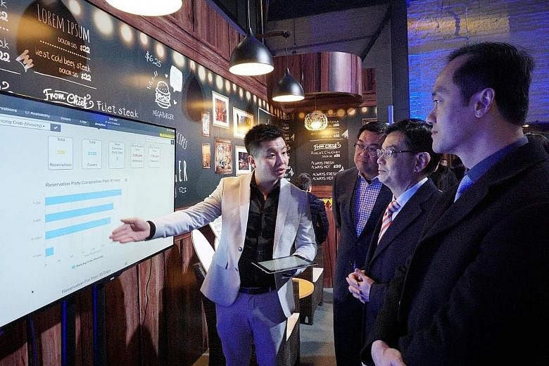 Finance Minister Heng Swee Keat being shown around the exhibits at the CapitaLand Tech and Innovation Summit at 798 Art Zone in Beijing yesterday.