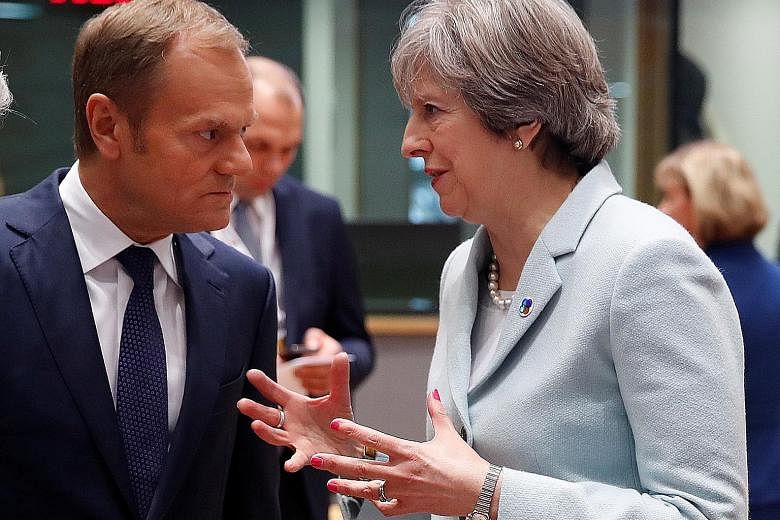 Britain's Prime Minister Theresa May speaking with European Council President Donald Tusk at the Eastern Partnership summit in Brussels, Belgium, yesterday.