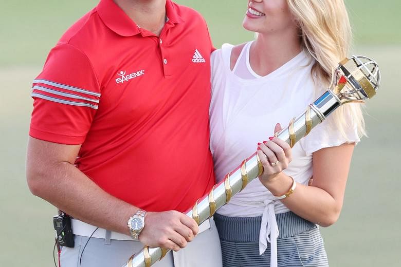 Jon Rahm of Spain with his girlfriend Kelley Cahill after winning the DP World Tour Championship at Jumeirah Golf Estates in Dubai last Sunday. Television commentators twice referred to the Spaniard as a "superstar" on the final day of the tournament