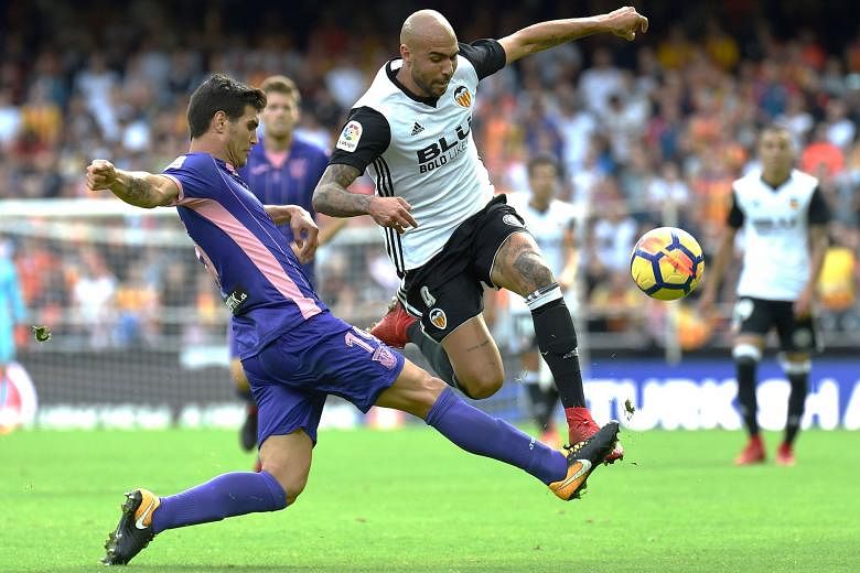 Leganes defender Ezequiel Munoz closing down Valencia forward Simone Zaza during their 0-3 loss on Nov 4 at the Mestalla. The Italian, who has been playing through the pain barrier, will be the danger man against leaders Barcelona, who will want to p