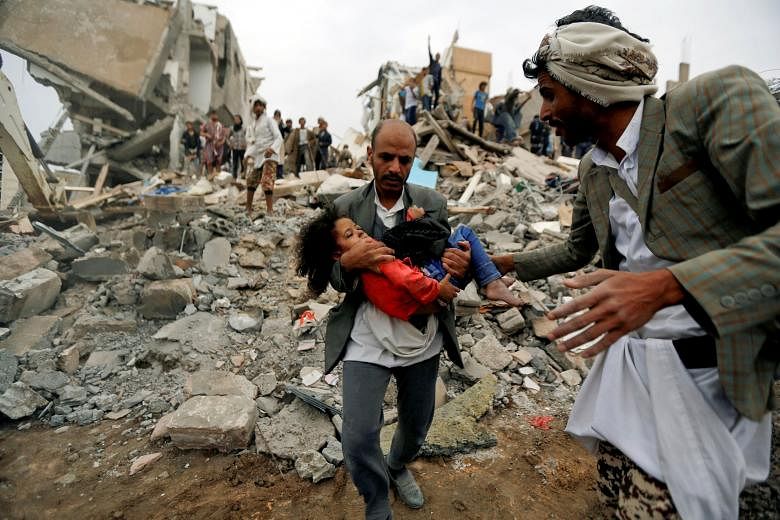 A man carrying an injured child rescued from the site of a Saudi-led air strike that killed eight of her family members in Sanaa, Yemen, in August. The writer says only Saudi Arabia can initiate a complete reboot of peace talks. It did so in 1965 to 
