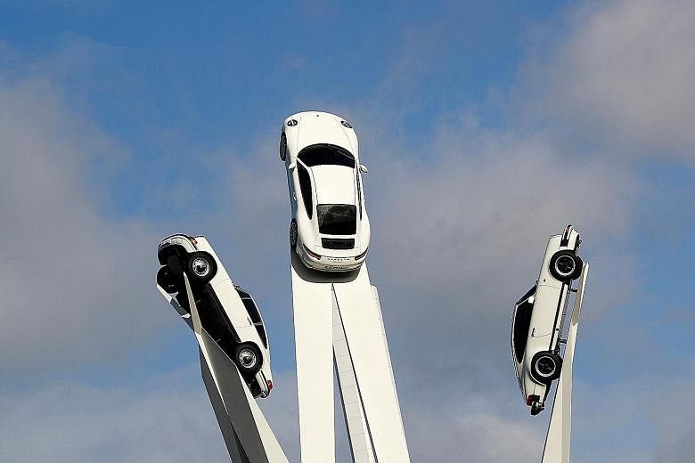 A sculpture featuring models of German sports car manufacturer Porsche outside the factory museum next to the Porsche headquarters in Stuttgart. The strong euro zone growth was powered by Germany, which shifted into an even higher gear in the third q