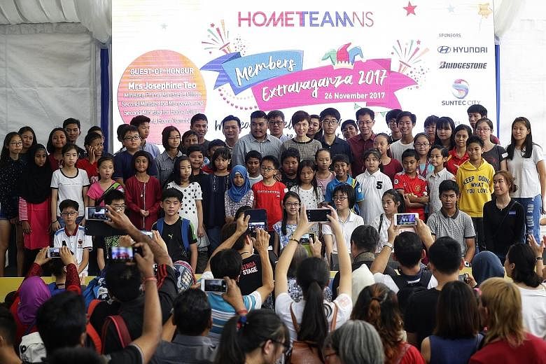 New HomeTeamNS president Josephine Teo (top row, centre) with recipients of the Children's Education Awards at the HomeTeamNS Members Extravaganza at Suntec City yesterday. She also launched #NSmemories for Home Team NSmen to remember their NS days.