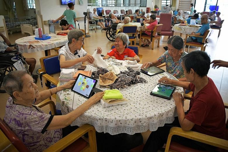 Residents at Lions Home for the Elders in Bishan. The home allows residents to wear their own clothes and has tightened its linen management process to ensure high hygiene standards.