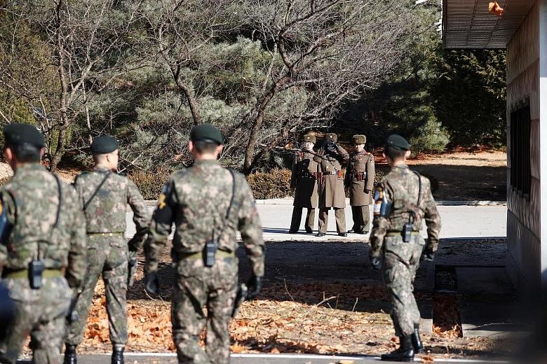 South and North Korean soldiers keeping watch on one another near the spot where a North Korean defected by crossing the border earlier this month.The South's Minister of Defence Song Young Moo commended the South Korean soldiers for rescuing the def