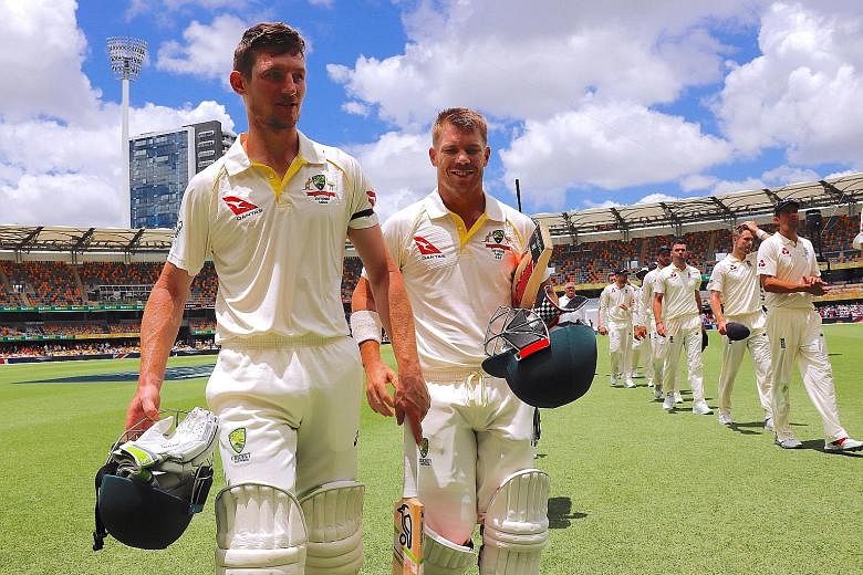 Australia's openers Cameron Bancroft (left, 82 not out) and David Warner (87 not out) after making short work of England in a 10-wicket first Ashes Test win in Brisbane yesterday.