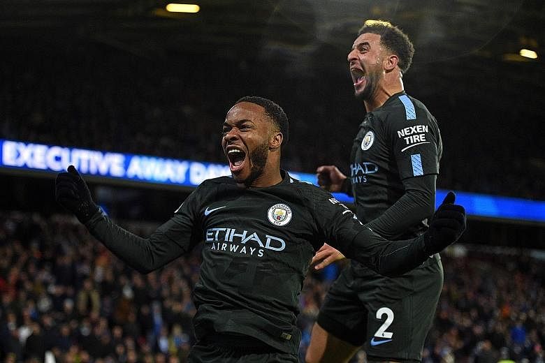 Manchester City winger Raheem Sterling (left) celebrating with Kyle Walker after his 84th-minute winner against Huddersfield on Sunday. The England international, one of City's stars this season, has scored 12 goals in 18 games in all competitions, h