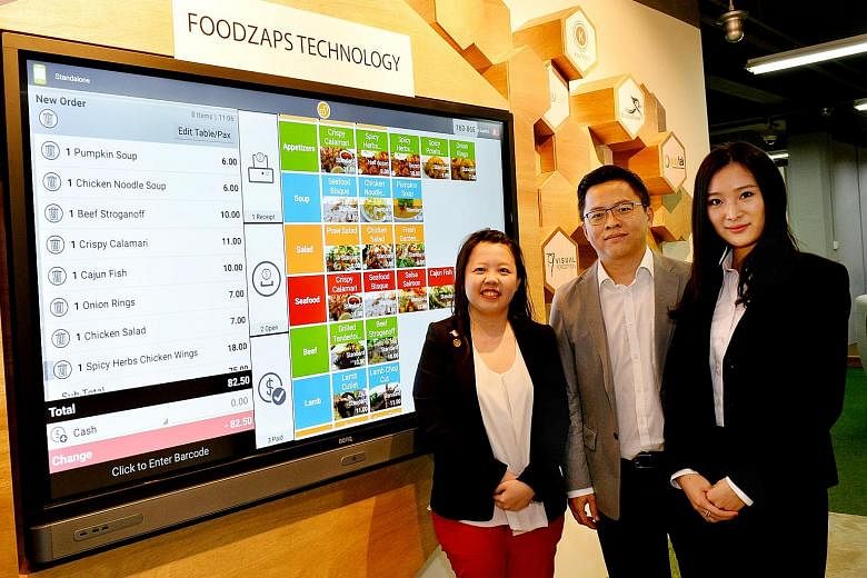 Mr Winson Tan, founder and technical director of FoodZaps Technology, with marketing director Rina Loh (far left) and director Chelsea Chan. The start-up, which provides restaurants with a subscription-based ordering software, has 60,000 registered r