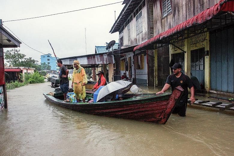 Malaysians living on the border between Malaysia and Thailand had to use a chartered boat to visit Thailand after the Golok River overflowed its banks yesterday. 	The monsoon floods sweeping the east coast of Malaysia have claimed their first victim 