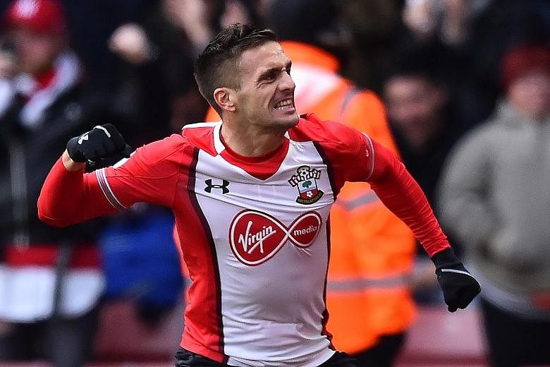 Southampton's Dusan Tadic celebrates his opener against Everton on Sunday. The attacking midfielder will carry the brunt of the responsibility of providing service for the Saints' strikeforce in a clash between two former team-mates in managers Mauri