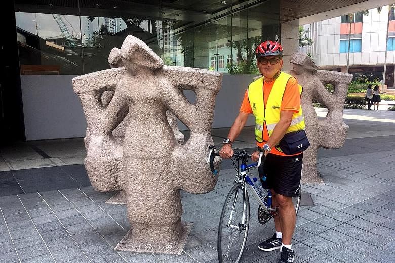 Standard Chartered Singapore Marathon official course measurer Dave Cundy next to the samsui women statues in front of the Urban Redevelopment Authority Building in Maxwell Road, not far from the 10km mark of Sunday's race.