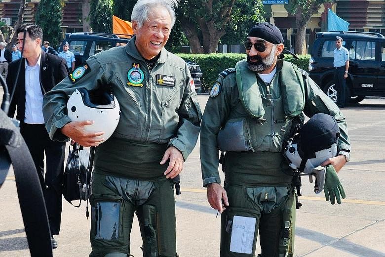 Defence Minister Ng Eng Hen and Air Vice-Marshal A.P. Singh on their way to board the Indian Air Force's Tejas Light Combat Aircraft during Dr Ng's visit to a joint training exercise at Kalaikunda Air Force Station in West Bengal yesterday.