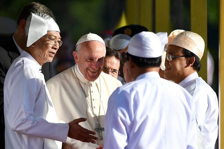 Pope Francis being welcomed yesterday by Myanmar President Htin Kyaw (left) during a ceremony at the Presidential Palace in Naypyitaw. Powerful military commander-in-chief Min Aung Hlaing met the Pope on Monday.