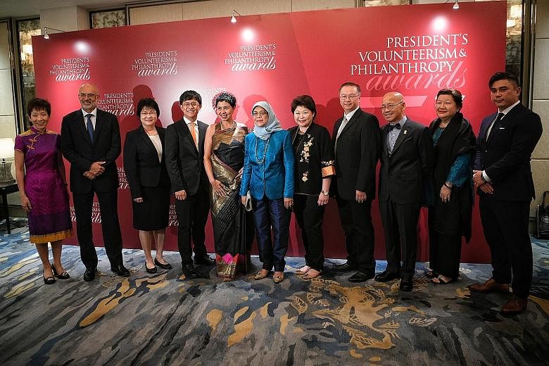 President Halimah Yacob (centre) is flanked by (from left) Minister for Culture, Community and Youth Grace Fu; DBS Group CEO Piyush Gupta; Hougang Secondary School vice-principal Yoong Jin Ing; Kodrah Kristang founder and director Kevin Martens Wong;