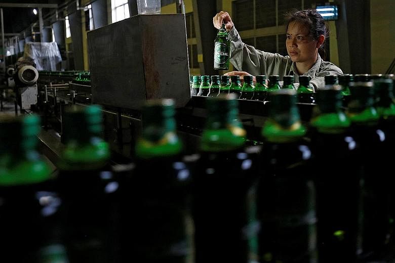 A worker checking beer bottles at a Sabeco factory in Vietnam. Shares of Sabeco have more than doubled since its listing last December on expectations of the stake sale.