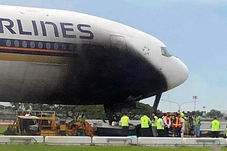 The SIA plane was left with a blackened patch after the tow tug pulling it to a departure gate at Changi Airport caught fire yesterday. There were no passengers on board at the time.