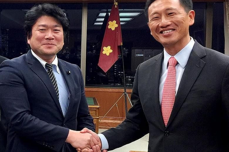 Minister for Education (Higher Education and Skills) Ong Ye Kung (at right) with Japanese State Minister of Defence Tomohiro Yamamoto at Japan's Ministry of Defence yesterday.