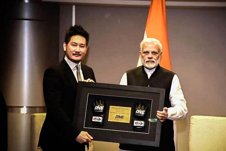 Chatri Sityodtong, the One Championship chairman, presents a souvenir to Indian Prime Minister Narendra Modi. The two men met on Tuesday and discussed the possibility of holding live events in India.