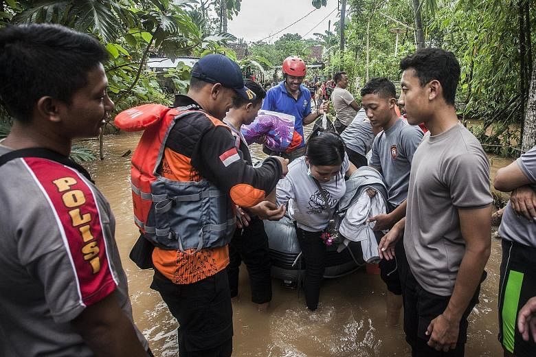 Indonesian police evacuating residents from a flooded village in Gunung Kidul, Yogyakarta, on Wednesday. Around 4,000 people are reportedly in dire need of evacuation after Cyclone Cempaka hit East Java earlier this week.