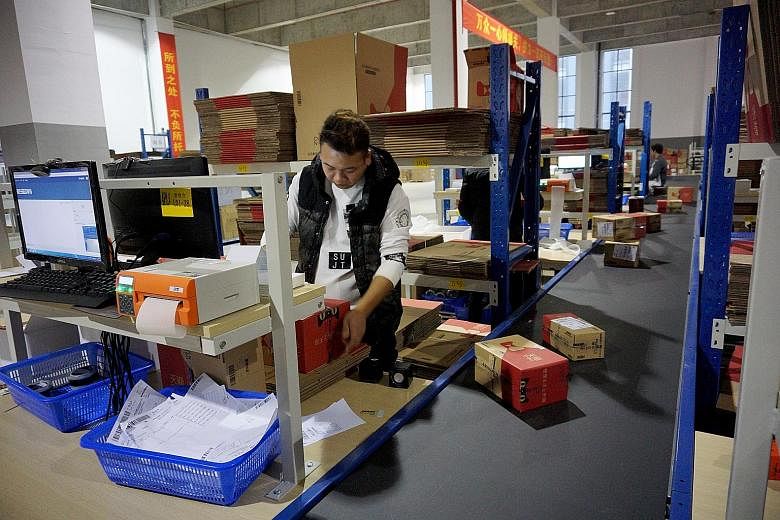 A worker at a Forchn Holdings warehouse in Hangzhou, Zhejiang province, tending to customers' e-commerce orders with the help of a digitised order and inventory management system.