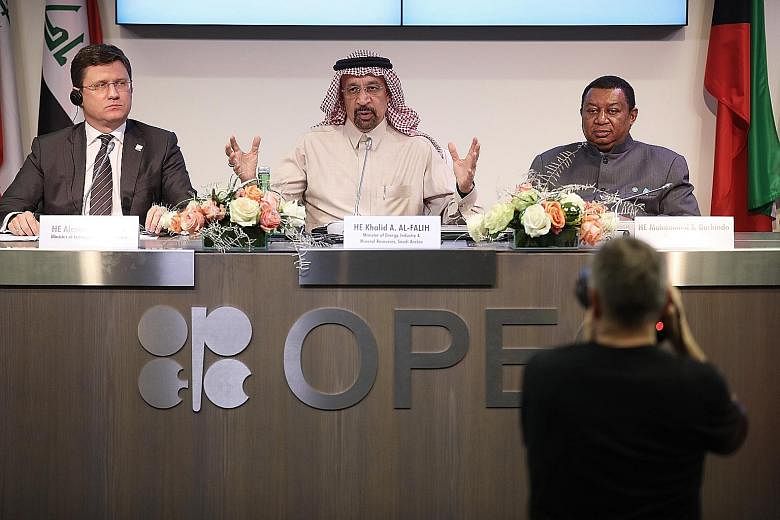 Saudi Arabia's Oil minister Khalid al-Falih speaking at a news conference following the Opec meeting in Vienna on Thursday. With him are Russian energy minister Alexander Novak (left) and Opec secretary-general Mohammed Barkindo.