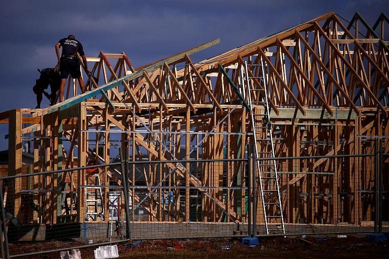 Builders working on the roof of a new house at a development in the western Sydney suburb of Oran Park in Australia, in October. With housing values falling in the country, there are concerns about erosion of consumer confidence.