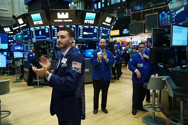 Traders applauding ahead of the closing bell on the floor of the New York Stock Exchange on Thursday. The Dow closed at over 24,000 points for the first time in its history that day.