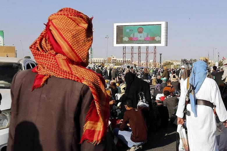 Houthi supporters watching the leader of the Houthis, Abdul-Malik al-Houthi, delivering a speech during a celebration marking the birthday of Prophet Muhammad in Sana'a, Yemen, on Thursday.