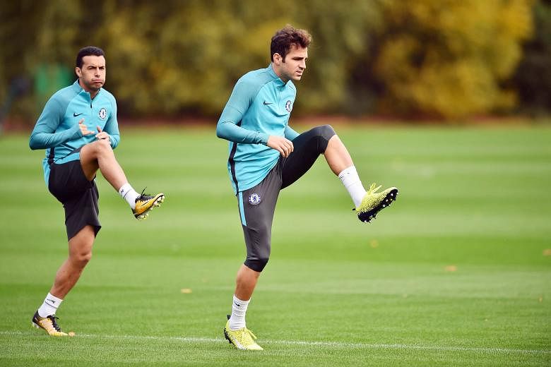 Cesc Fabregas (right, warming up with Pedro) promises that Chelsea be will dogged in their pursuit of leaders Manchester City.
