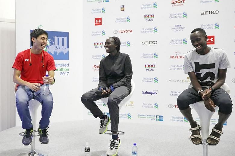 Singapore's two-time SEA Games marathon champion Soh Rui Yong sharing a light moment with Kenyan runners Rebecca Chesir and Cyprian Kotut during the Standard Chartered Singapore Marathon elite runners' press conference at Marina Bay Sands yesterday.