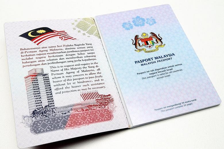 The inside cover of the new Malaysian passport has songket motifs, while national landmarks are featured on other pages.