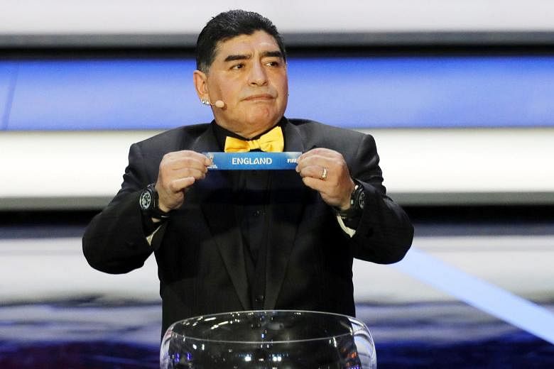 Draw assistant for the night, former Argentinian international and World Cup winner Diego Maradona, showing the ticket of England as he gives the English a lucky break with his hands for once.