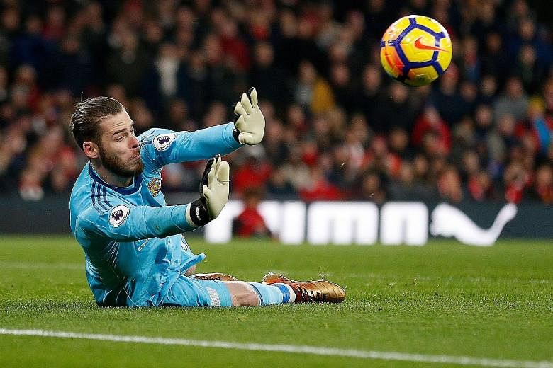 David de Gea dives to his right to deny Arsenal's Sead Kolasinac - one of his 14 saves against the Gunners. The Spanish goalkeeper's imperious showing was a major factor in Manchester United's 3-1 victory.