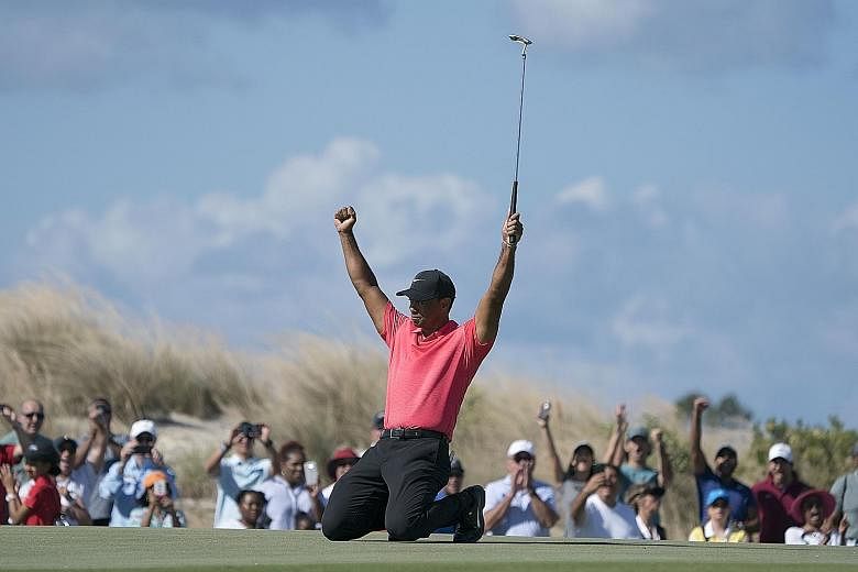 Tiger Woods celebrating after making his eagle putt on the seventh hole during the final round of the Hero World Challenge at Albany Golf Club, much to the delight of the crowd. The 41-year-old completed his first tournament in 12 months following ye