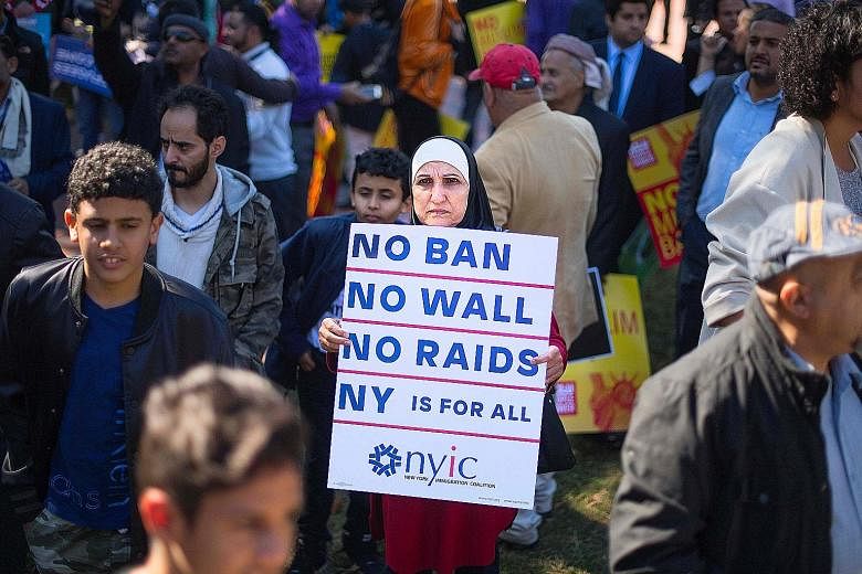 A demonstrator in Washington during a #NoMuslimBanEver rally and march in October. The US Supreme Court on Monday allowed to take effect President Donald Trump's latest travel ban targeting people from Chad, Iran, Libya, Somalia, Syria and Yemen.
